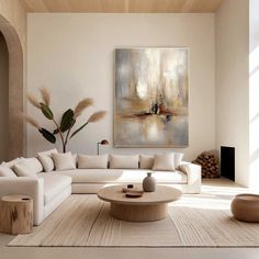 a living room filled with furniture and a painting on the wall