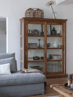 a living room filled with furniture and lots of shelves on top of it's sides