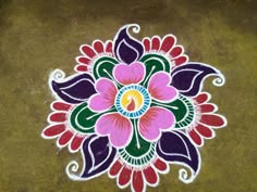 colorful flower design painted on the ground with white and pink flowers in it's center