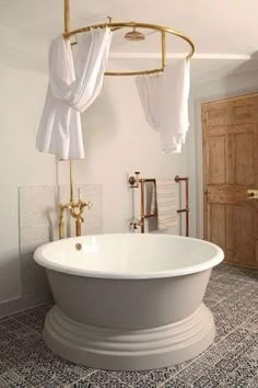 a white bath tub sitting inside of a bathroom