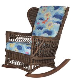 a wicker rocking chair with blue and white fabric on the seat cushion, in front of a white background