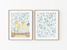 two framed pictures of ducks in a bathtub with blue and green leaves on the wall