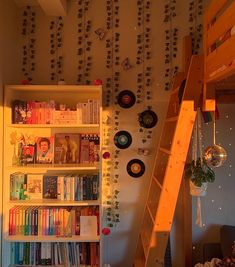 there is a book shelf with many books on it and a ladder to the top