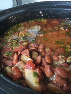 a crock pot filled with beans and broccoli