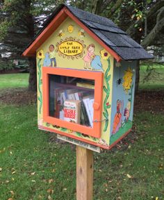 a colorful bird house with books in it