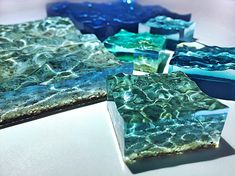 several pieces of glass sitting on top of a white countertop next to each other