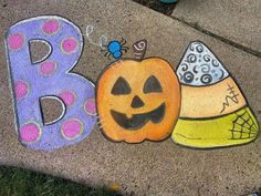 the sidewalk has been decorated with chalk to spell out b is for pumpkin and hat