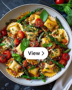 a white bowl filled with pasta and vegetables