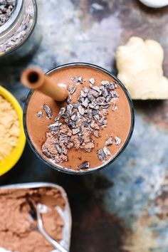 an overhead view of a chocolate smoothie in a glass next to other desserts