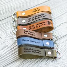 four leather keychains with personalized names on them