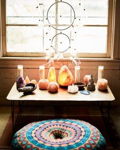 a table topped with candles next to a window