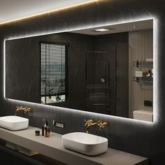 a bathroom with two sinks and a large mirror over it's counter top,