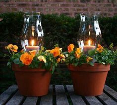 three pictures of pots with flowers in them and one has candles on the potted planter