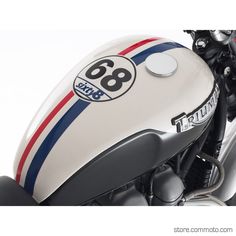 the front end of a white motorcycle with red, white and blue stripes on it