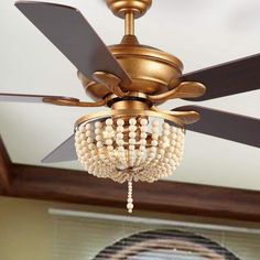 a ceiling fan with beads hanging from it's blades