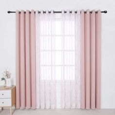 pink curtains hanging on the side of a white wall next to a dresser with drawers