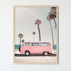 a pink van parked in front of palm trees