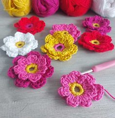 crochet flowers and yarn on a table