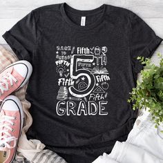 Step into the realm of fifth grade in style with our vibrant 5th Grade Teacher Shirt! This playful design is a love letter to all fifth grade maestros, a stylish way to show your students that you're more than a teacher, you're their fifth grade champion. The design centers around the phrase "5th Grade," crafted in the style of nostalgic chalkboard doodles. Surrounding it are endearing illustrations of school accessories, infusing the shirt with a charm that's as delightful as a day in the class 5th Grade Shirts, 5th Grade Shirt, School Team Shirts, Fifth Grade Teacher, 5th Grade Teacher, Chalkboard Doodles, Teacher T Shirts, Typography Shirts, School Accessories