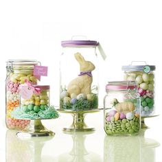 there are many glass jars with candy and candies in them