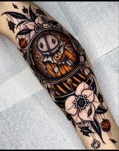 an owl in a clock with flowers on it's arm is shown from the side