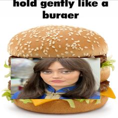 a woman is standing in front of a hamburger with the caption hold gently like a burger