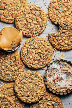 several cookies with sprinkles and a cookie spoon