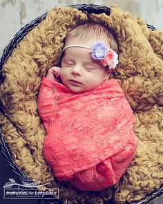 a newborn baby wrapped in a pink blanket