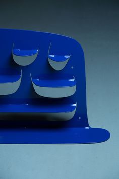 a blue and white plate with five plates on it's side, in the shape of a boat