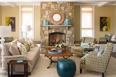 a living room filled with furniture and a fire place in the middle of a room