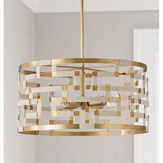 a gold chandelier hanging from the ceiling in a room with white walls and flooring