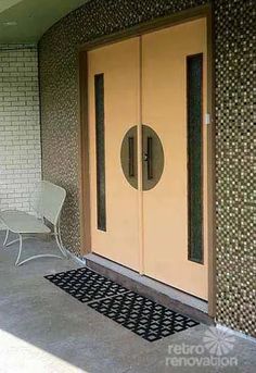 two chairs sitting on the front porch of an apartment building with doors and sidelights