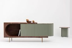 the sideboard is made out of wood and has two birds perched on top of it