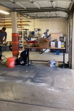 two men working in a garage with tools