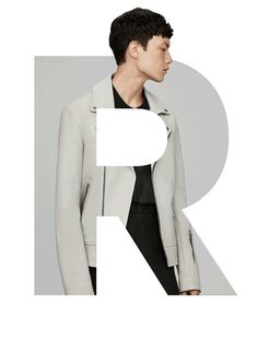 a man wearing a white jacket and black pants with the letter r in front of him