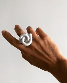 "The Cloud Knot Ring is a collection of contemporary acrylic design inspired by its symbolism of love, connection and binding. It also symbolizes peace, unity, protection and liberation. I made this ring while listening to the song \"I want to break free\" from the album The Works by Queen. The song is a symbolism of the fight against oppression and women's liberation movement. Each piece is unique allowing for collectors to style themselves with contemporary wearable design. 100% Acrylic | Hand Modern Twist White Jewelry For Gifts, White Jewelry With A Modern Twist As A Gift, White Jewelry With A Modern Twist For Gifts, Modern White Open Ring, Adjustable White Symbolic Rings, White Modern Twist Ring Jewelry, Modern White Rings For Gifts, Modern Twist White Rings As Gift, White Rings With A Modern Twist As A Gift