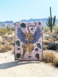 a blanket with an image of a tiger on it in the middle of a desert