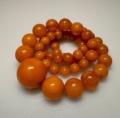 64 Grams Antique Bakelite Necklace Beads Marbled.           Very quality necklace with round shape. All beads have rich veins. 59 total beads Biggest bead sizes 29 mm.  Smallest bead sizes 9 mm. For any questions feel free to as Round Polished Beads For Jewelry Making, Round Beads For Jewelry Making, Polished Round Beads For Jewelry Making, Amber Beads For Jewelry Making, Vintage Beaded Necklace With Polished Beads, Vintage Beaded Necklaces With Polished Beads, Vintage Round Beaded Necklaces With Polished Beads, Orange Beaded Necklace With Faceted Beads, Vintage Round Necklaces With Polished Beads