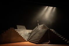 a man standing on top of a set of stairs in the middle of a stage