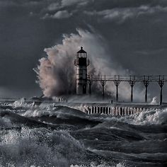 a lighthouse surrounded by waves in the ocean