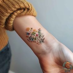 a woman's arm with flowers on it