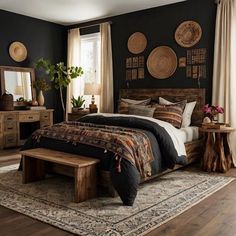 a bed room with a neatly made bed next to a wooden table and mirror on the wall