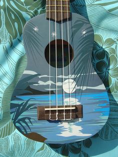 the ukulele is painted with an image of a bird on it's neck