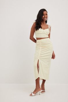 This midi skirt features a material in linen blend. It has gathered details on the sides and a self-tie drawstring on one side. This midi skirt features a hidden side zipper closure and a side slit. Future Fashion, Strap Top, Strap Tops, Yellow Flower, Yellow Flowers, Women Empowerment, Linen Blend, Side Zipper, Yellow White