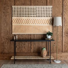 a room with wood paneling and a rug on the floor next to a table