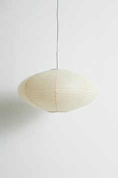 a white paper lantern hanging from a ceiling