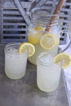 lemonade in mason jars with ice and wooden spoon