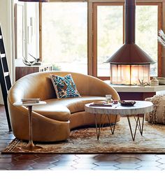 a living room filled with furniture and a fire place in the middle of the room