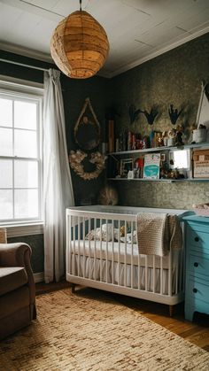 a baby's room with a crib, dresser and chair