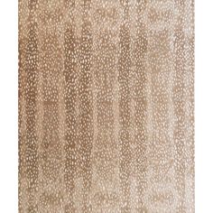 an area rug with brown and white spots on it